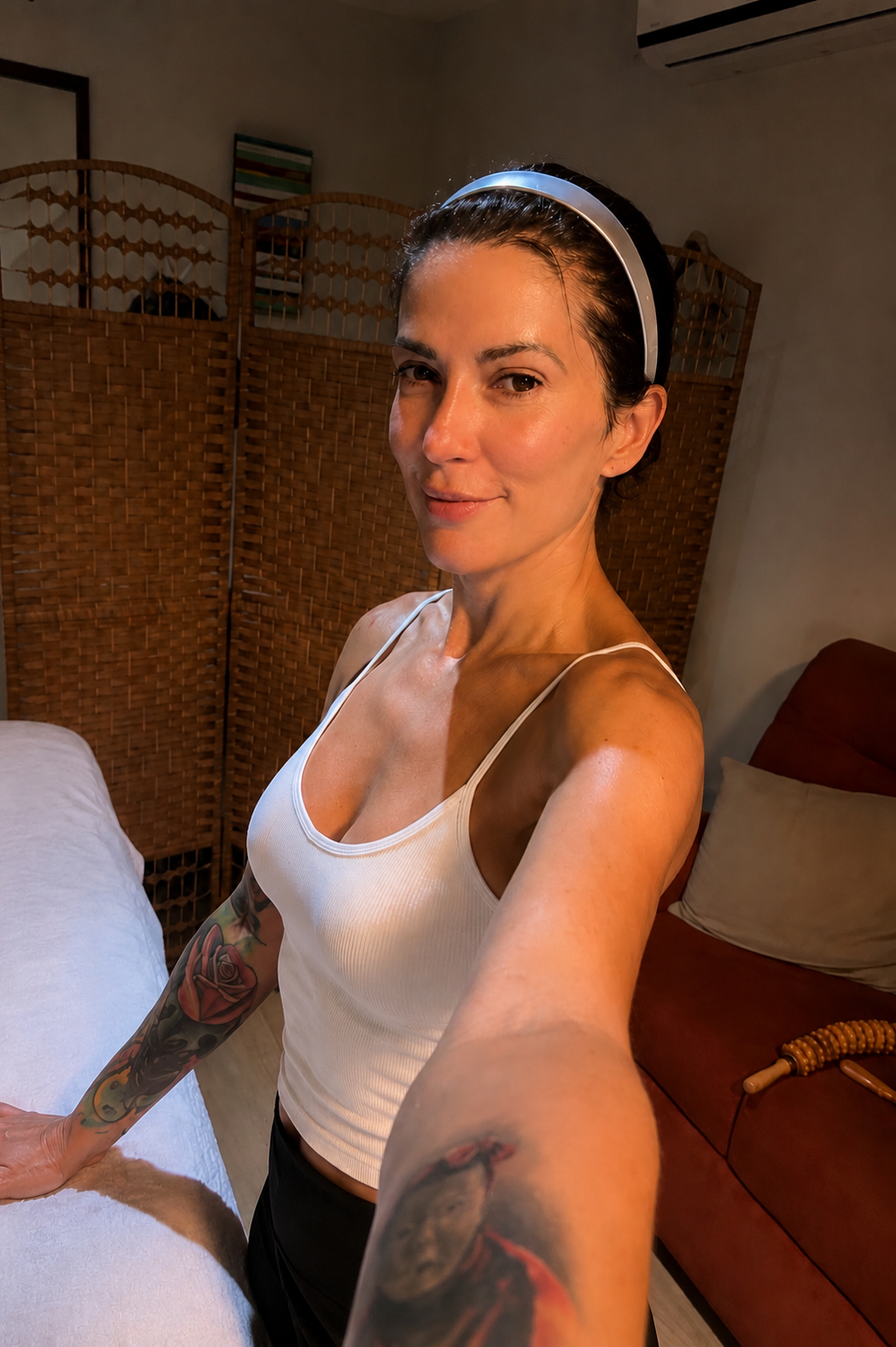 Melissa beside the massage table in her studio